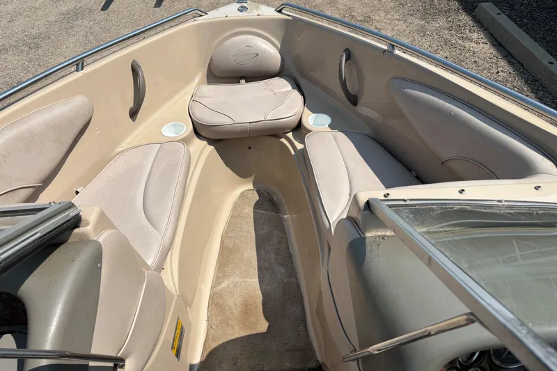 Slide: The Image of 2001 Crownline 18' boat interior with beige seating and cup holders. - 12