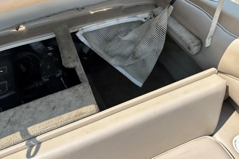 Slide: The Image of Open storage compartment in a 2001 Crownline 18' boat, showing interior details. - 16