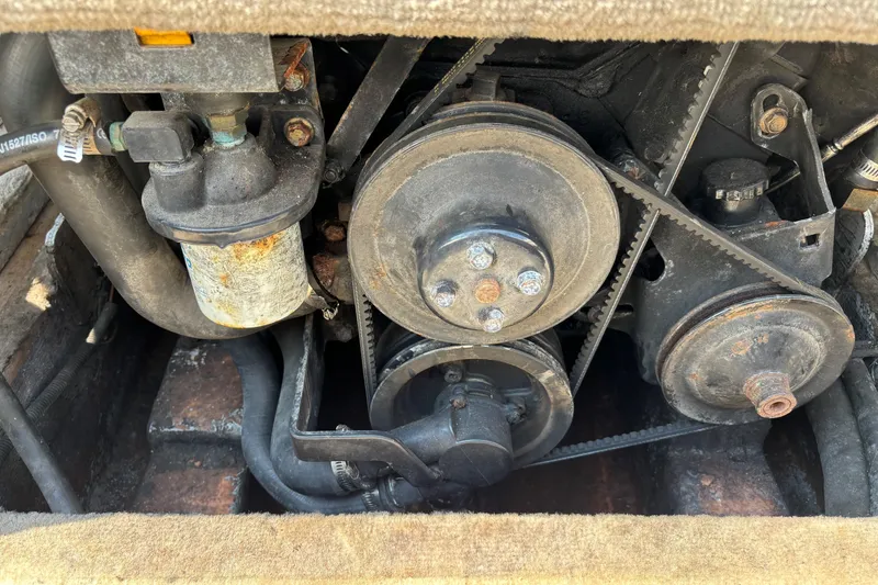 Slide: The Image of Engine components of a 2001 Crownline 18' boat, featuring belts and pulleys. - 21