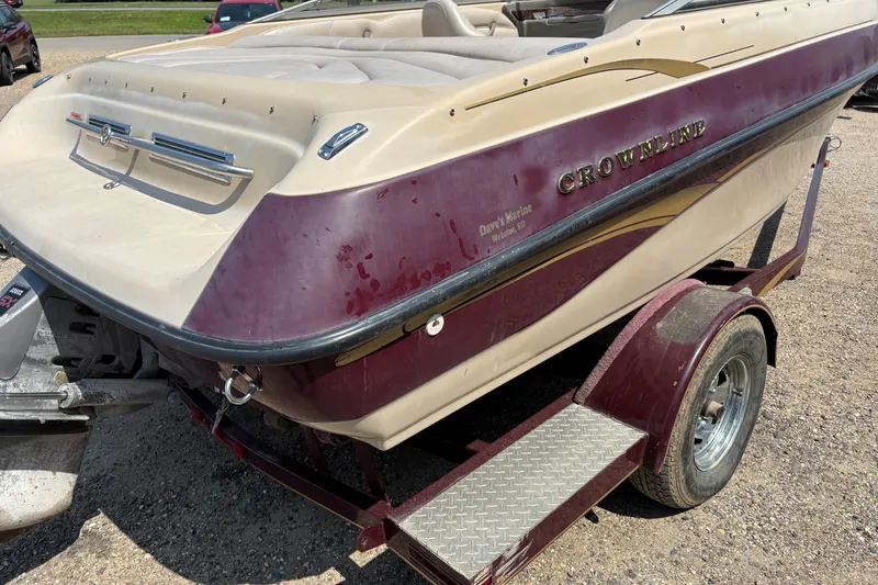 Slide: The Image of 2001 Crownline 18' boat on trailer, maroon and beige color scheme, parked outdoors. - 5