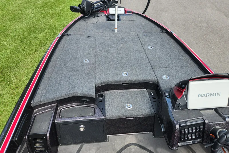 Slide: The Image of 2025 Triton 21XP Patriot boat deck with Garmin electronics and storage compartments. - 10