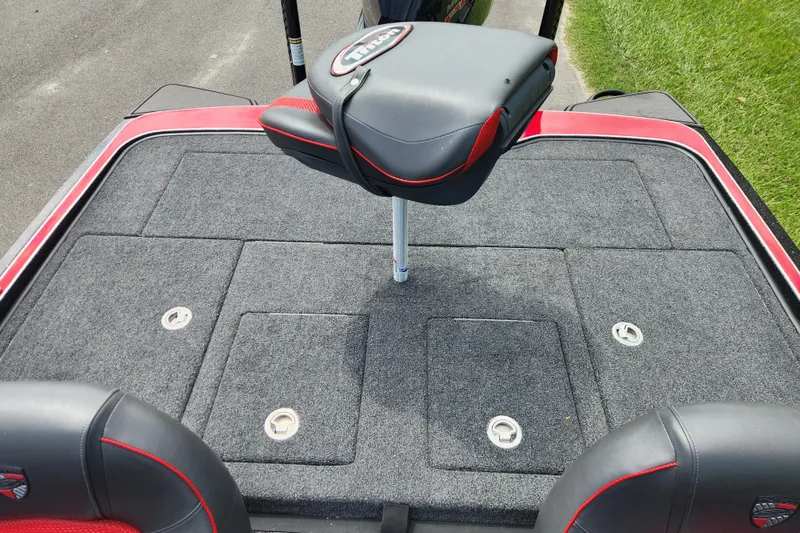Slide: The Image of 2025 Triton 21XP Patriot boat deck with seating and storage compartments. - 13