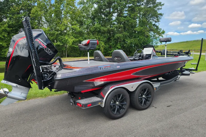 Slide: The Image of 2025 Triton 21XP Patriot boat with sleek design, dual axles, and powerful outboard motor. - 2