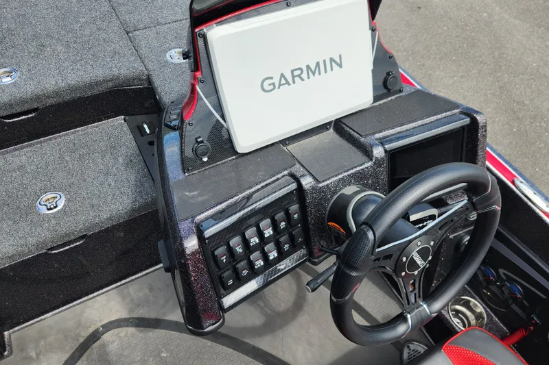 Slide: The Image of 2025 Triton 21XP Patriot boat dashboard with Garmin navigation system and steering wheel. - 9