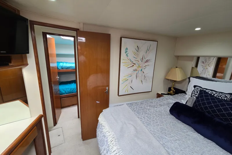 Slide: The Image of 1998 Viking 58 Convertible yacht at marina, view from interior with boats and blue sky. - 29