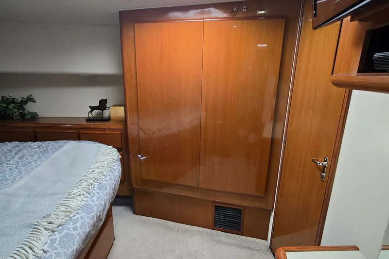 Slide: The Image of Interior view of a 1998 Viking 58 Convertible yacht with white seating and cabinetry. - 30