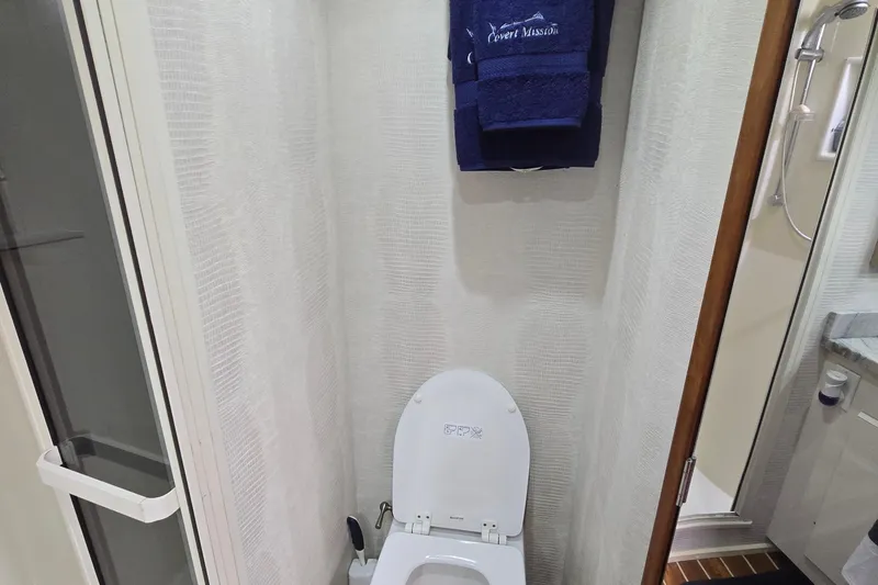 Slide: The Image of 1998 Viking 58 Convertible boat deck with wood flooring and storage compartments. - 33