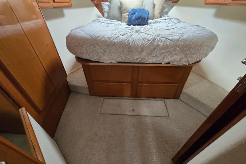 Slide: The Image of 1998 Viking 58 Convertible yacht deck with wooden flooring and sleek white railings. - 34