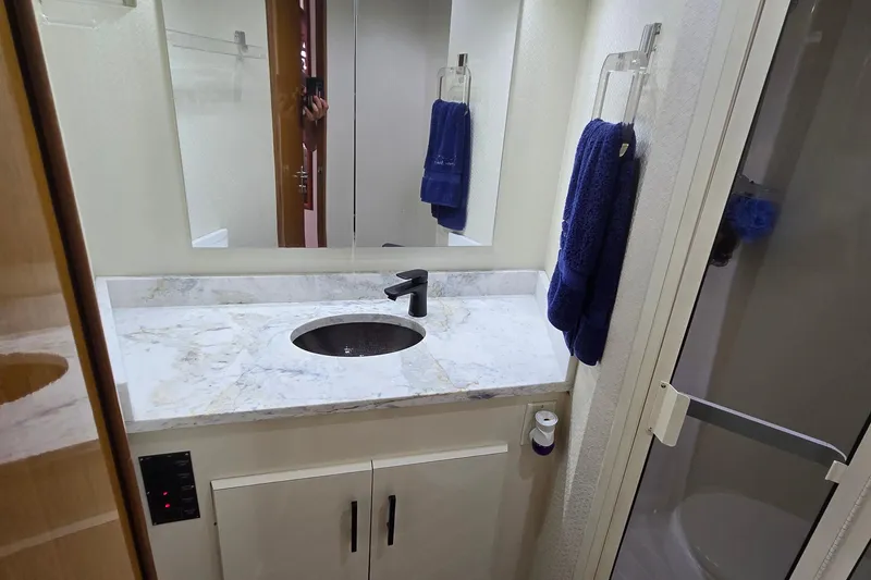 Slide: The Image of 1998 Viking 58 Convertible yacht deck with fishing chair and teak flooring. - 36