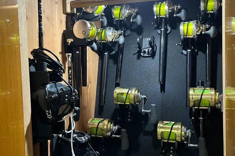 Slide: The Image of 1998 Viking 58 Convertible yacht docked at marina, showcasing spacious deck and tower. - 38