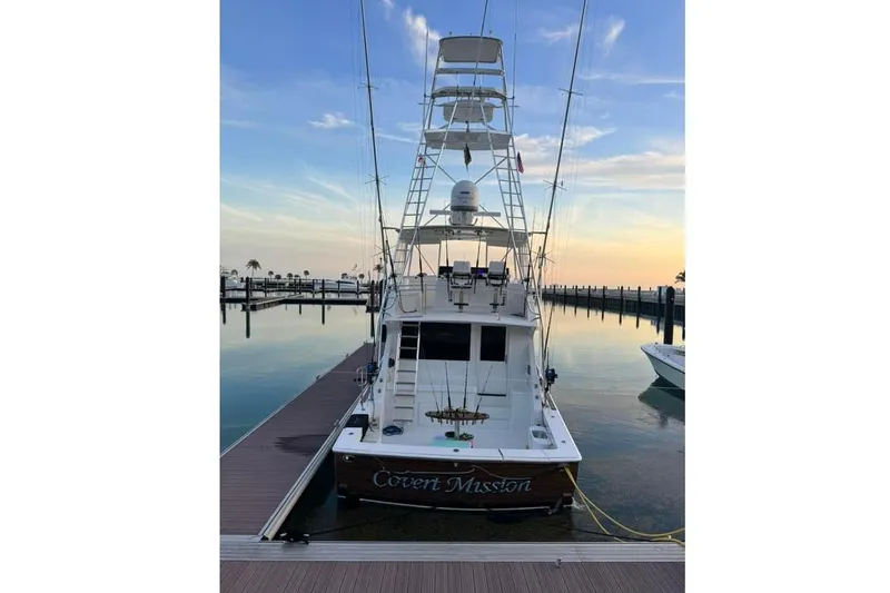 Slide: The Image of Luxurious interior of a 1998 Viking 58 Convertible yacht with plush seating and decorative pillows. - 7