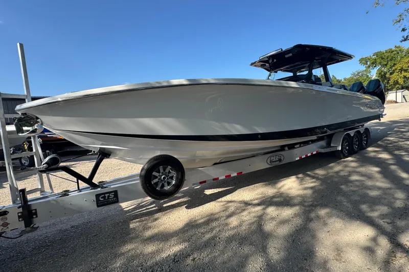 Slide: The Image of 2024 Nor-Tech 400 Supersport boat interior with luxurious seating and powerful engines. - 14