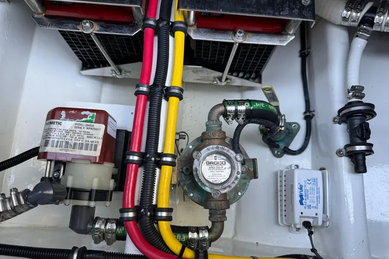 Slide: The Image of 2024 Nor-Tech 400 Supersport boat on trailer, surrounded by trees at sunset. - 23