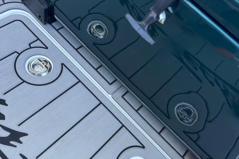 Slide: The Image of 2024 Nor-Tech 400 Supersport boat on trailer, parked on driveway with lush greenery. - 27