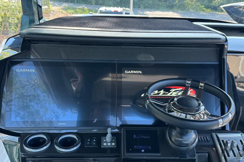 Slide: The Image of 2024 Nor-Tech 400 Supersport boat cockpit with advanced navigation system and luxurious seating. - 31