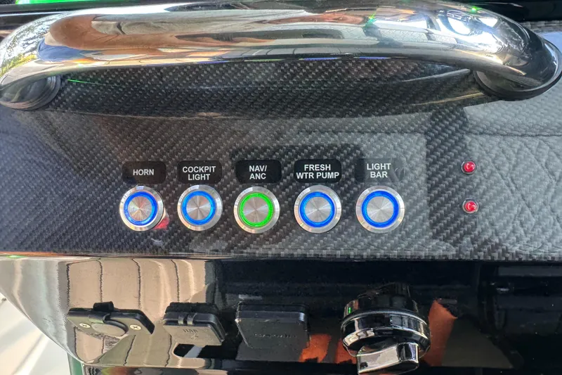 Slide: The Image of 2024 Nor-Tech 400 Supersport boat on trailer, parked outdoors with trees in background. - 35