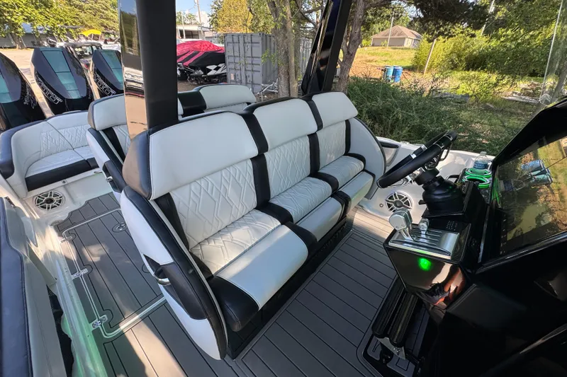 Slide: The Image of 2024 Nor-Tech 400 Supersport boat with open sunroof, surrounded by trees and clear sky. - 43