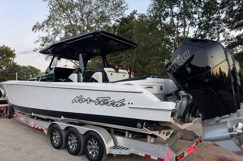 Slide: The Image of 2024 Nor-Tech 400 Supersport boat on trailer, sleek design, parked outdoors. - 6