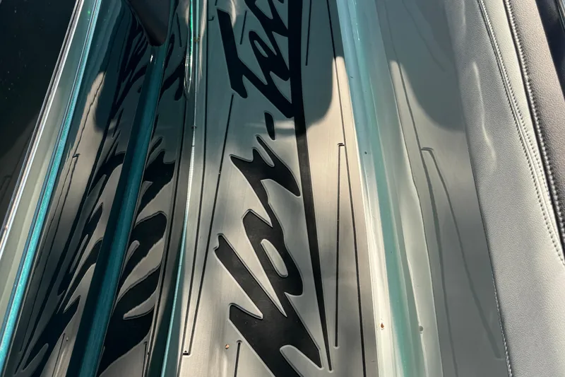 Slide: The Image of 2024 Nor-Tech 400 Supersport boat with open hatch, docked outdoors. - 72