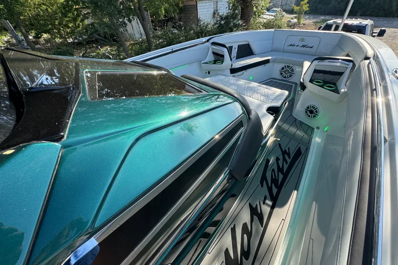 Slide: The Image of 2024 Nor-Tech 400 Supersport boat with open hatch and sleek deck design. - 73