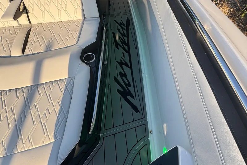 Slide: The Image of 2024 Nor-Tech 400 Supersport boat with luxurious seating, docked outdoors. - 78