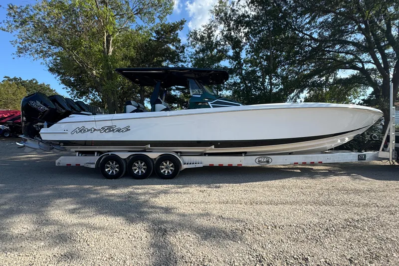 Slide: The Image of 2024 Nor-Tech 400 Supersport boat on trailer, parked outdoors, showcasing sleek design. - 8