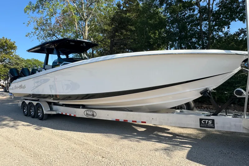 Slide: The Image of 2024 Nor-Tech 400 Supersport boat on trailer, featuring four powerful engines. - 9