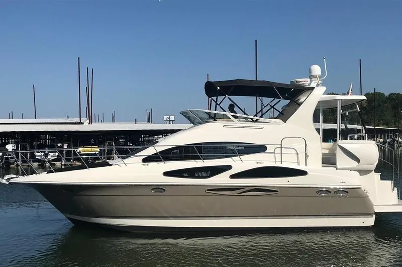 The Image of 2008 Cruisers Yachts 395 Motoryacht docked in a marina under clear blue skies. - 0