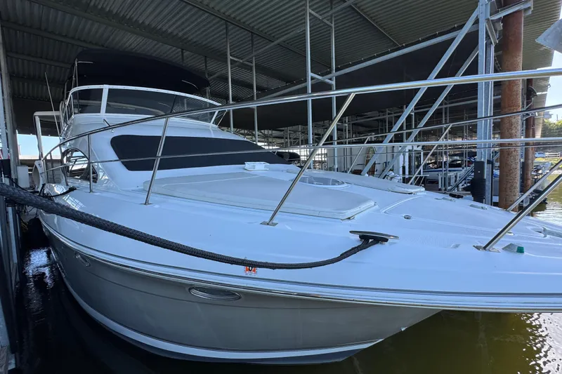 Slide: The Image of 2008 Cruisers Yachts 395 Motoryacht docked under a covered marina. - 17