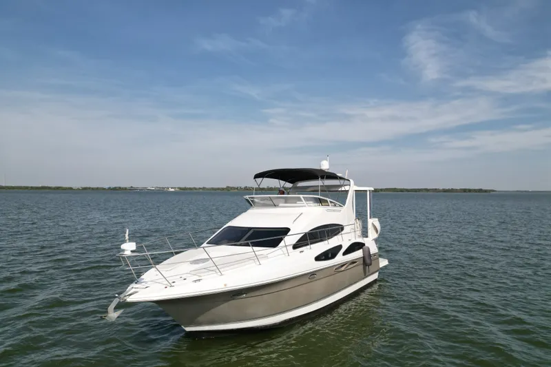 Slide: The Image of 2008 Cruisers Yachts 395 Motoryacht on calm water under a clear blue sky. - 1