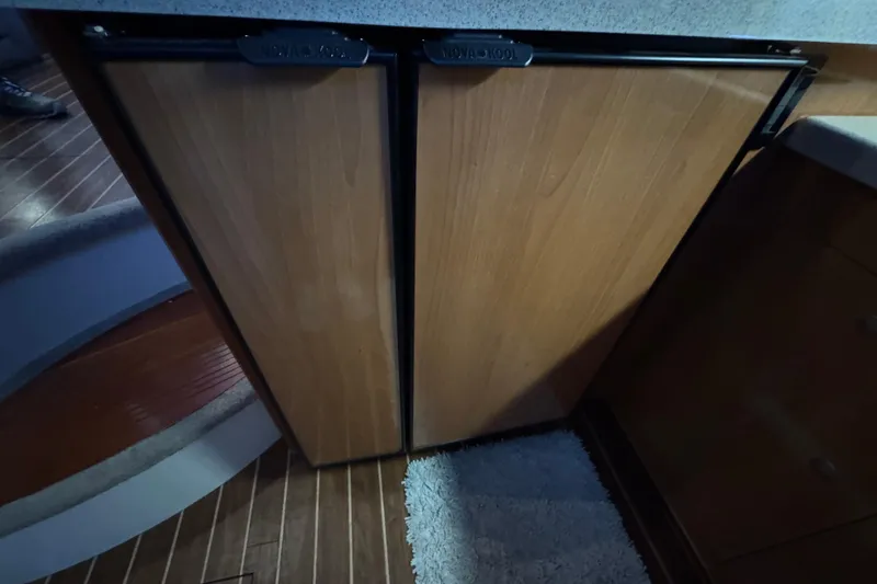 Slide: The Image of 2008 Cruisers Yachts 395 Motoryacht interior with wooden cabinetry and carpeted flooring. - 27