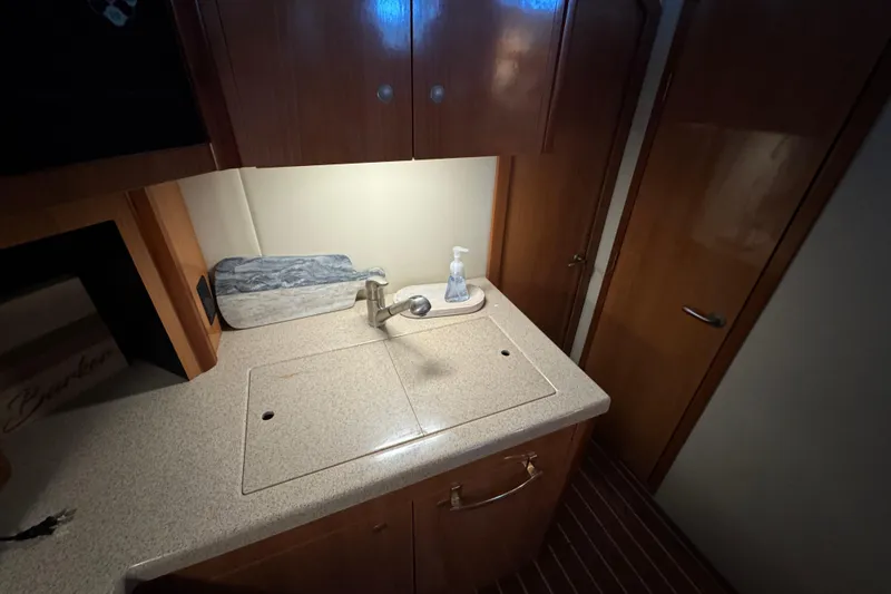 Slide: The Image of 2008 Cruisers Yachts 395 Motoryacht interior with sink and wooden cabinetry. - 29