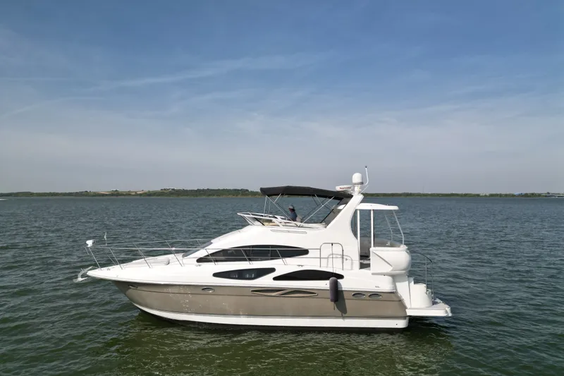 The Image of 2008 Cruisers Yachts 395 Motoryacht on calm water under clear blue sky. - 0