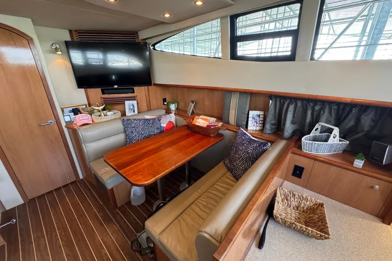 Slide: The Image of 2008 Cruisers Yachts 395 Motoryacht interior with dining area, TV, and wooden accents. - 36