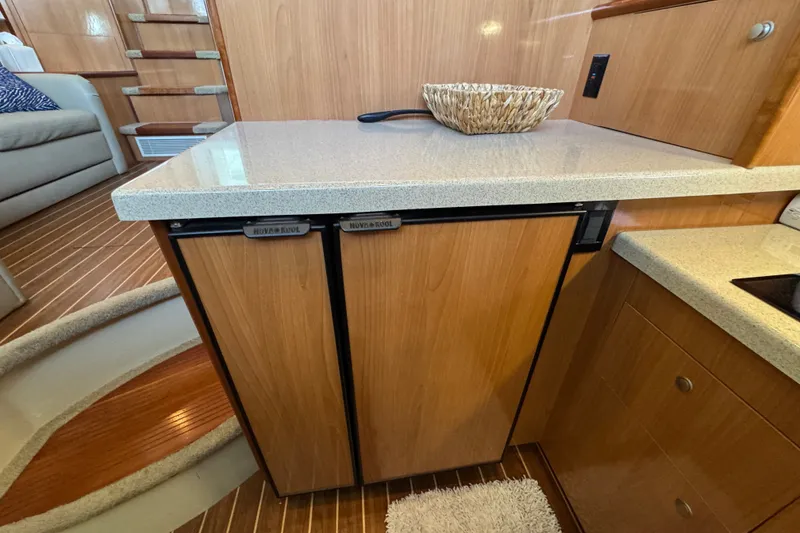 Slide: The Image of Interior of 2008 Cruisers Yachts 395 Motoryacht with wooden cabinetry and compact refrigerator. - 44