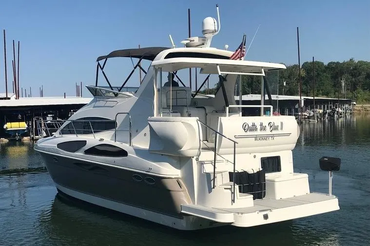 Slide: The Image of 2008 Cruisers Yachts 395 Motoryacht docked in a marina, rear view. - 4
