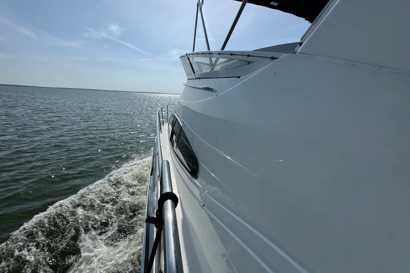 Slide: The Image of 2008 Cruisers Yachts 395 Motoryacht cruising on open water under clear skies. - 8