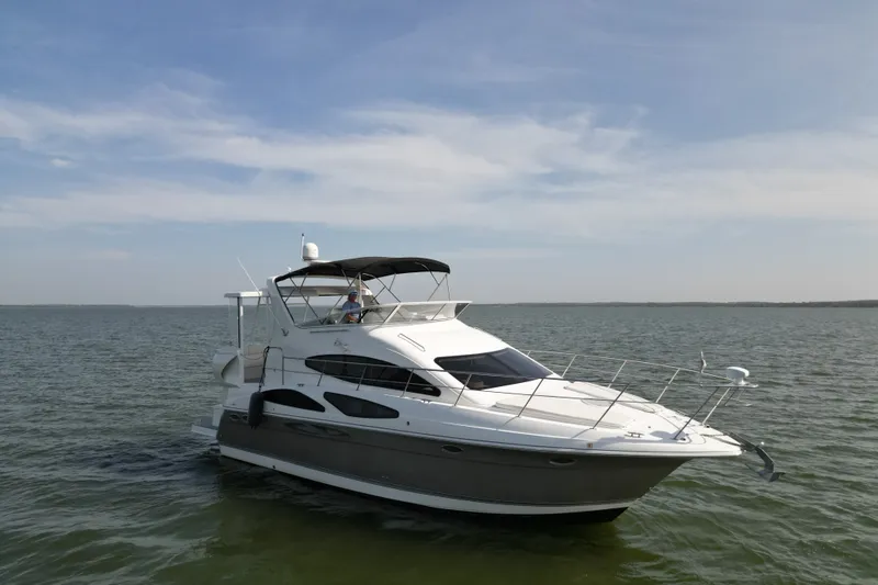 Slide: The Image of 2008 Cruisers Yachts 395 Motoryacht on calm water under clear sky. - 2