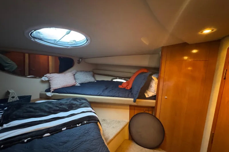 Slide: The Image of 2008 Cruisers Yachts 395 Motoryacht interior cabin with cozy bedding and wooden cabinetry. - 52