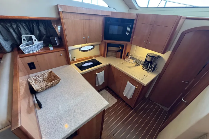 Slide: The Image of 2008 Cruisers Yachts 395 Motoryacht kitchen with modern appliances and wooden cabinetry. - 39