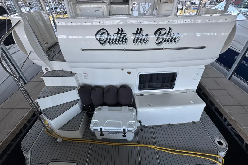 Slide: The Image of 2008 Cruisers Yachts 395 Motoryacht stern with "Outta the Blue" name, docked. - 13