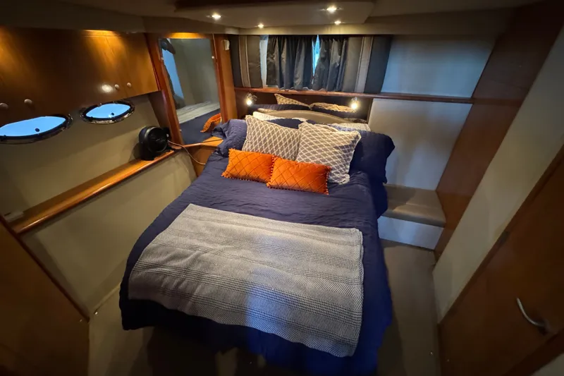 Slide: The Image of Luxurious bedroom interior of 2008 Cruisers Yachts 395 Motoryacht with cozy bedding and ambient lighting. - 56
