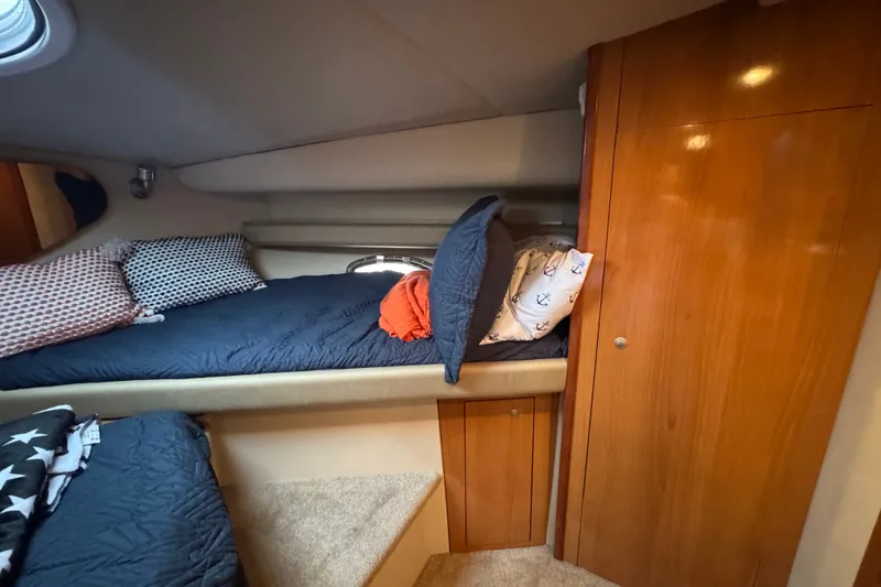 Slide: The Image of Cozy cabin interior of 2008 Cruisers Yachts 395 Motoryacht with wooden cabinetry and bedding. - 49