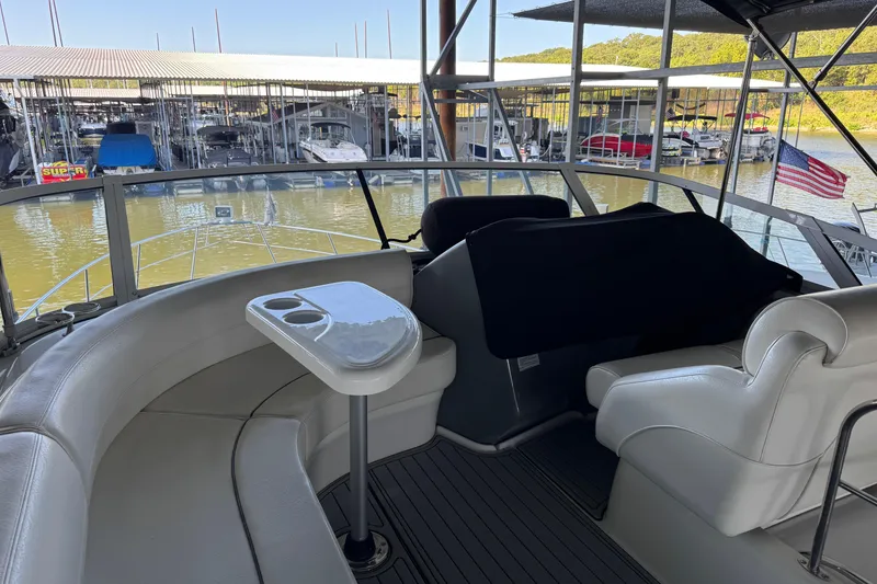 Slide: The Image of 2008 Cruisers Yachts 395 Motoryacht interior with seating, table, and marina view. - 34