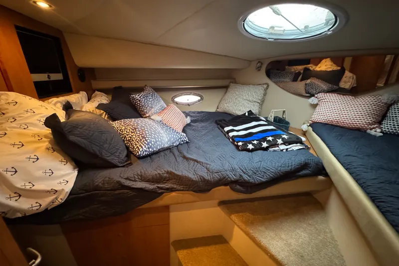 Slide: The Image of Luxurious 2008 Cruisers Yachts 395 Motoryacht bedroom with cozy bedding and porthole window. - 48