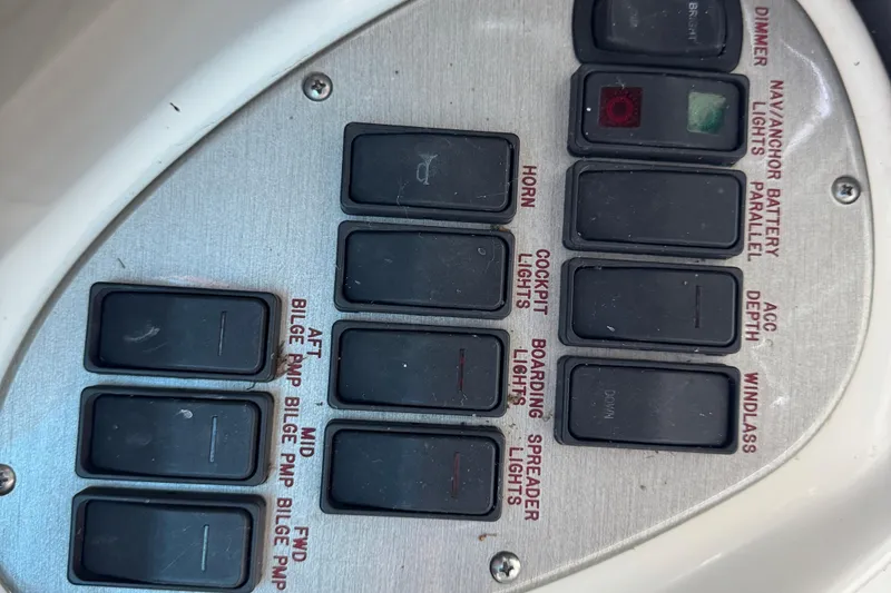 Slide: The Image of Control panel of a 2008 Cruisers Yachts 395 Motoryacht with labeled switches. - 28