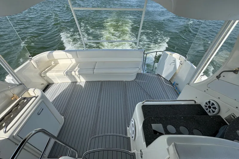 Slide: The Image of 2008 Cruisers Yachts 395 Motoryacht deck with seating, overlooking ocean waves. - 10
