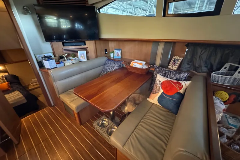 Slide: The Image of 2008 Cruisers Yachts 395 Motoryacht interior with cozy seating and wooden table. - 23