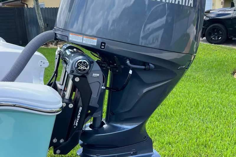 Slide: The Image of 2024 Sea Hunt BX 22 BR boat with Yamaha outboard motor on grass. - 13