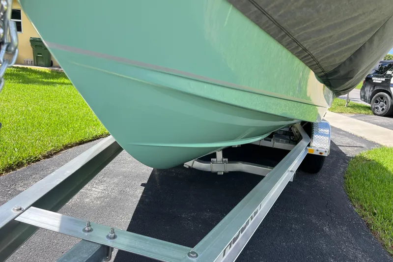 Slide: The Image of 2024 Sea Hunt BX 22 BR boat on trailer, parked on driveway. - 15